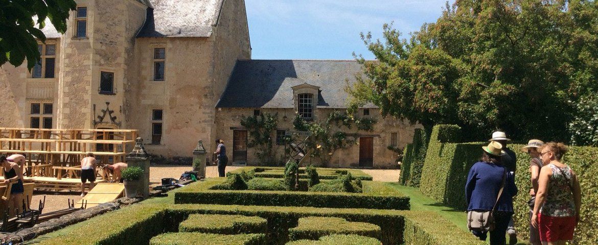 vue de jardins à la française avec une partie d'un château dans le fond